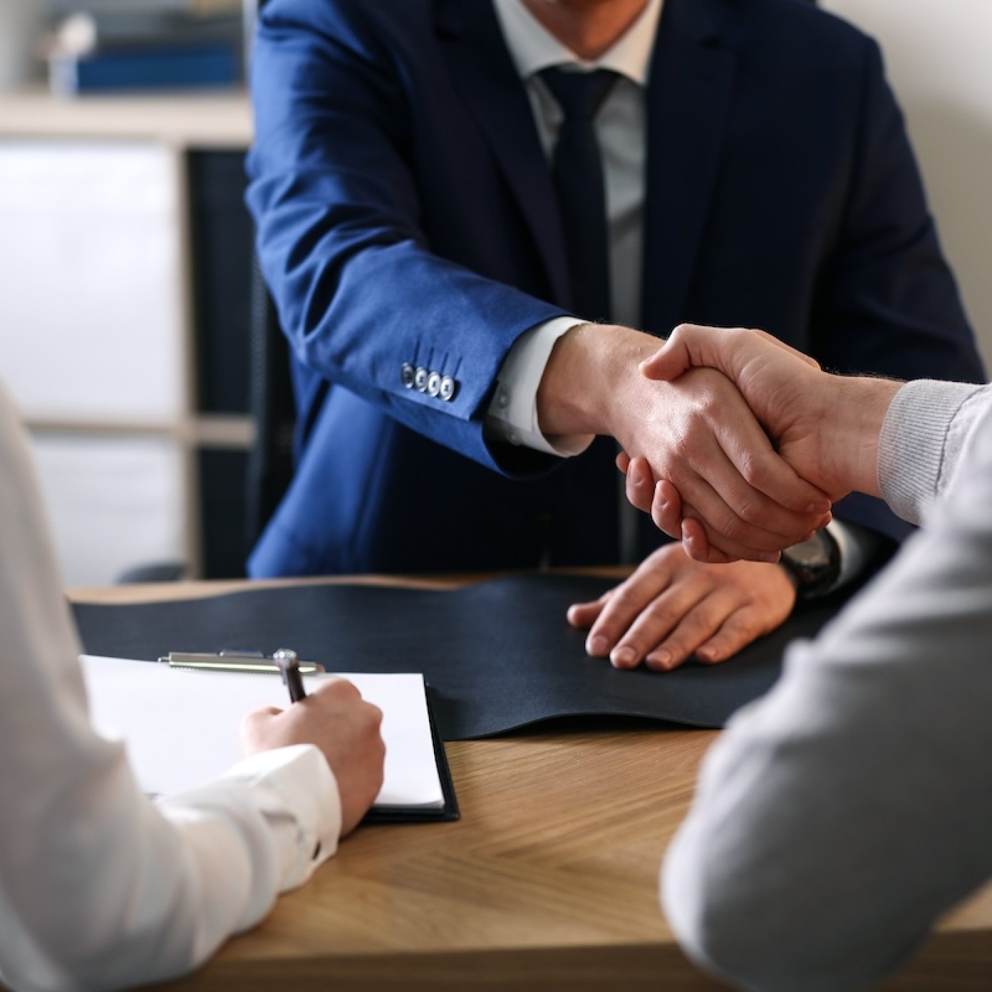 Male lawyer working with clients in office, closeup